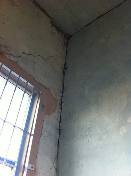 Internal cracks in the walls were visible in the masonry; cracks were evident at the junction between the internal masonry walls and the external walls, caused by insufficient lateral restraint, Belfast, Co. Antrim, NI