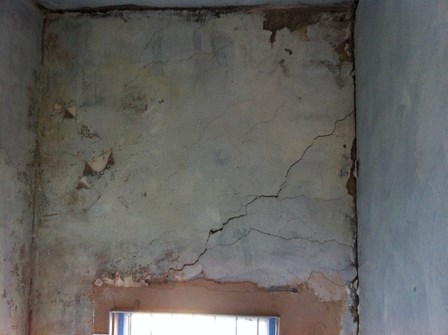 Cracks in the masonry walls above windows, due to a failed lintel, at Belfast, Co. Antrim, Northern Ireland