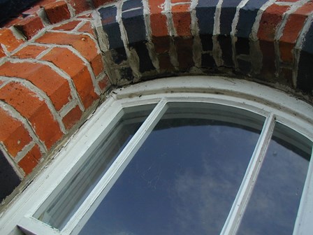 Replacement wall ties required.  Brickwork cracking around window arches, at Magilligan, Co. Derry, Northern Ireland