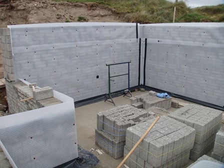 Cavity drain basement waterproofing membrane mechanically fixed to blockwork retaining wall, at Co. Donegal, Ireland